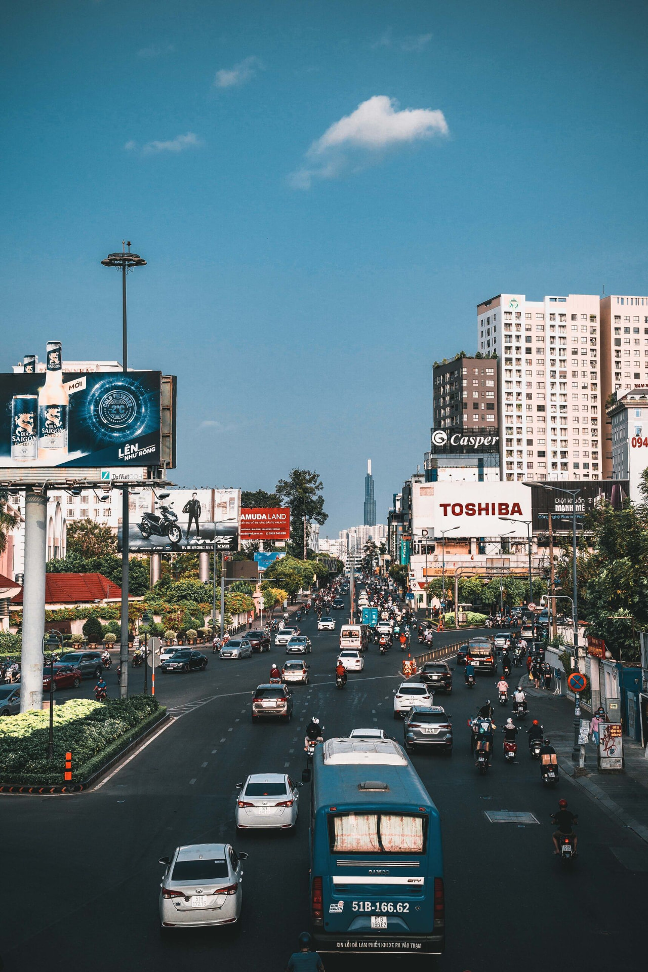 Busy city street in Ho Chi Minh City with billboards and traffic